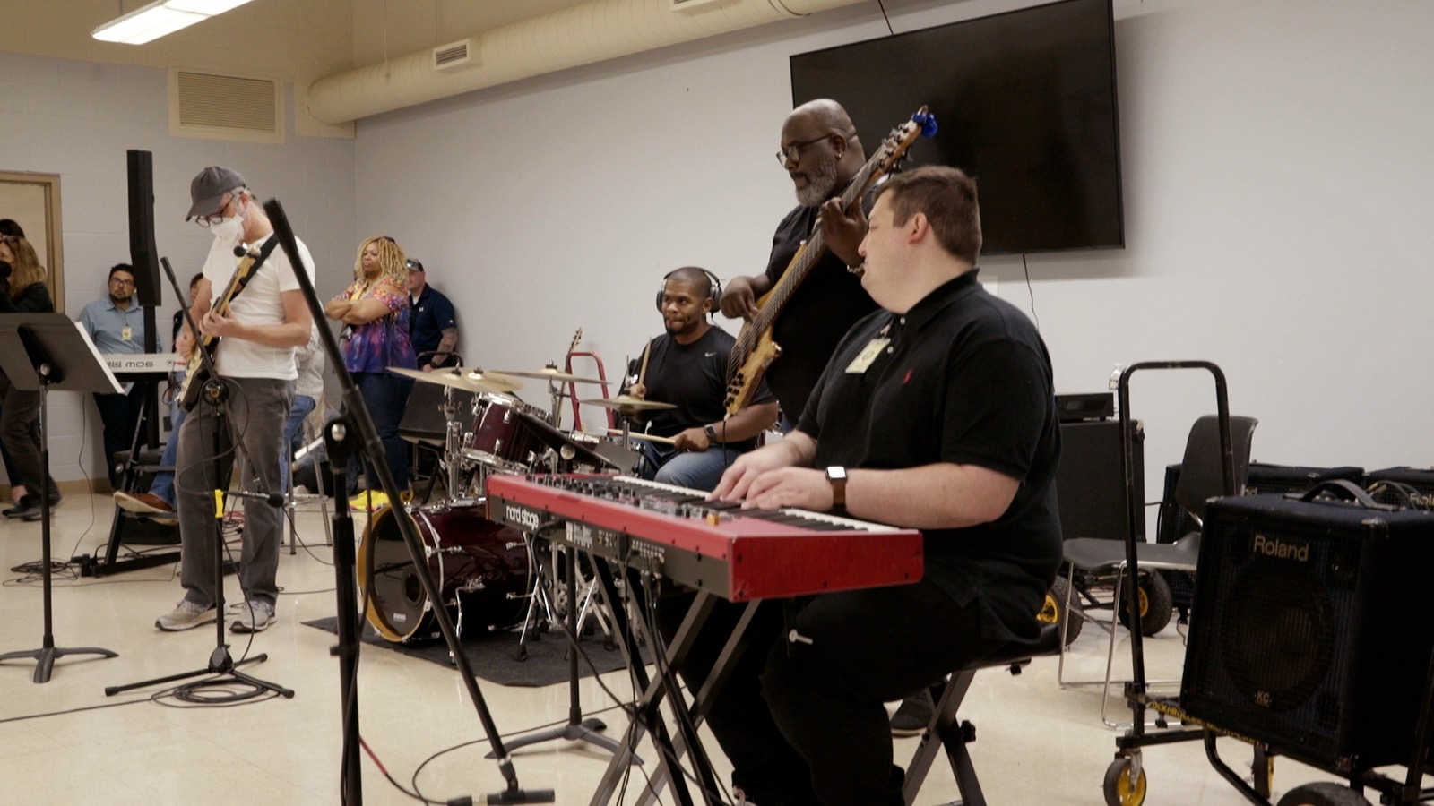 The Harmony Project band playing together: keyboard, bass, electric guitar and drums.